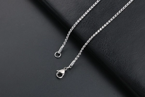 Detailed macro view of the silver twist chain necklace with a sturdy lobster clasp closure