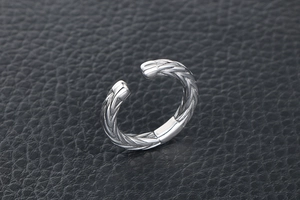 Macro view showing the vintage wheat pattern texture on a silver titanium steel open ring