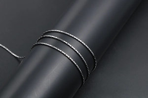 Macro shot of minimalist silver stainless steel chain with flat rectangular links