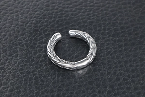 Macro shot of silver wheat pattern titanium steel open ring with woven texture