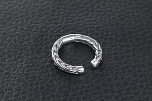 Macro shot of titanium steel wheat ear ring with intricate braided texture design
