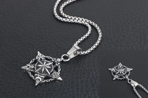 Macro view of vintage star pendant featuring gothic skull and moon relief details