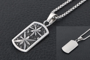 Close-up of vintage stainless steel dog tag with embossed star on rock texture