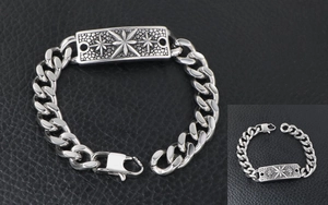Détail d'un bracelet gourmette argenté vintage avec motif étoile gravé et fermoir mousqueton