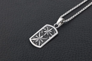 Detailed macro of vintage titanium steel dog tag pendant featuring embossed star patterns