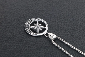 Close-up of vintage crescent moon and star pendant with Celtic knot on a box chain