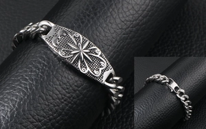 Close-up of vintage punk star bracelet with lobster clasp on black leather
