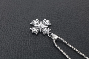 Vue macro du pendentif croix en acier inoxydable vintage avec relief d'étoile