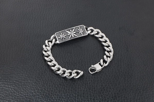 Detail of vintage silver titanium steel bracelet with engraved octagonal stars on black leather