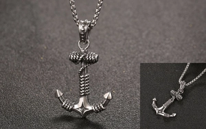 Macro shot of vintage oxidized anchor pendant with rope detail on steel pearl chain