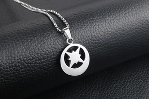Detailed macro shot of silver stainless steel star pendant with a polished box chain