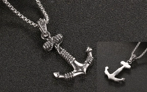 Detailed macro view of vintage stainless steel anchor pendant with rope texture and box chain