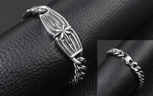 Detail of silver curb chain bracelet featuring 3D star engraving and lobster clasp