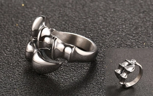 Detail of vintage punk beast claw ring showing bone joints and polished silver finish
