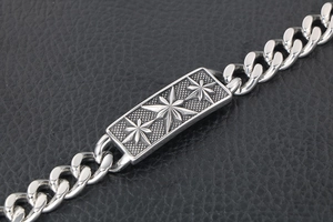 Detailed macro view of vintage titanium steel Cuban bracelet with star engraved plaque