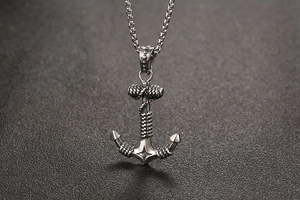 Close-up of vintage punk anchor pendant with rope details on a silver box chain