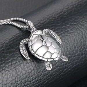 Polished titanium steel sea turtle pendant necklace with detailed geometric shell on black leather