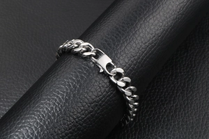 Close-up of heavy stainless steel cuban link bracelet with classic lobster clasp closure
