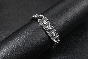 Detailed macro view of vintage titanium steel Cuban link bracelet with star engravings