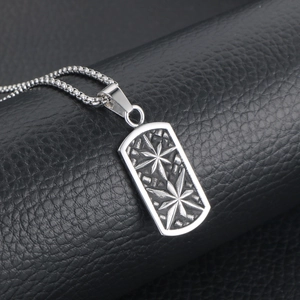 Vintage stainless steel military tag necklace with star relief on black leather background