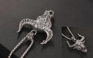 Macro shot of silver goat head pendant with detailed horns and vintage oxidized finish