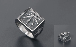 Detailed close-up of vintage industrial seal ring with embossed leaf pattern engraving