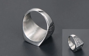 Detailed macro view of the silver steel ring featuring intricate side geometric engravings
