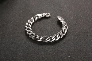 Vista macro del bracciale punk a catena cubana argento con chiusura a moschettone e maglie