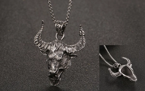 Detail view of vintage stainless steel ox head pendant with oxidation texture and hollow back