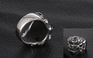 Macro detail of retro stainless steel wide ring with intricate mythical beast engraving
