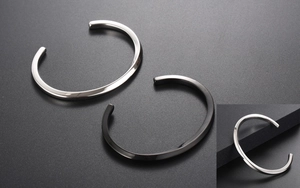 Macro shot of silver and black twisted cuff bracelets with polished mirror finish