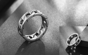 Detail of high-polished stainless steel curb chain ring showing punk hollow structure
