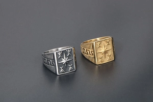 Detail of gold and silver signet rings with octagonal star and Greek key pattern