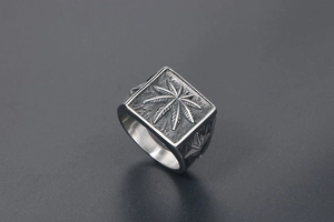 Macro detail of retro punk men's leaf ring with engraved vintage silver textures