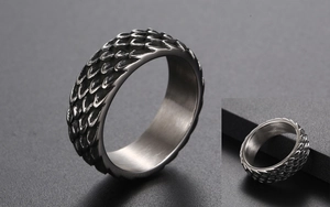 Detailed macro shot of vintage stainless steel ring with intricate dragon scale textures