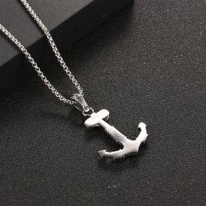 Polished silver anchor pendant necklace with box chain on a dark textured background