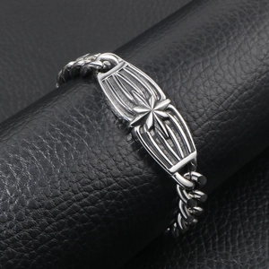 Men's silver Cuban link bracelet with engraved star emblem on a steel plate