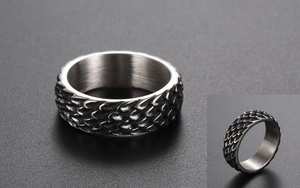 Macro shot of vintage titanium steel ring featuring detailed dragon scale texture