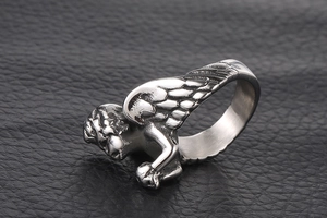Vue latérale macro de la bague ailes d'ange en acier titane avec plumes détaillées