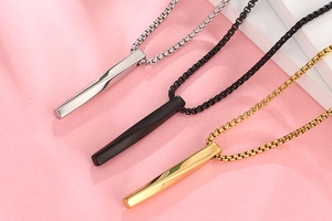 Detailed shot of twisted bar pendants in silver black and gold with box chains