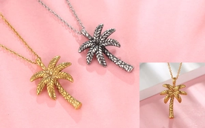 Macro view of gold and silver palm tree pendants with detailed textures and fine chains