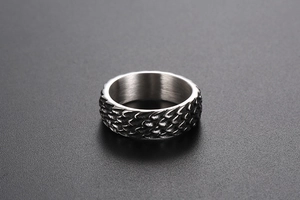 Detailed view of vintage titanium steel ring with textured dragon scale pattern