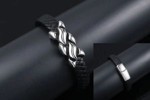 Close-up of men's braided leather bracelet with magnetic clasp and steel ornament
