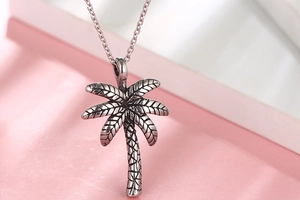 Close-up of a two-tone coconut tree pendant necklace with vintage oxidized silver finish