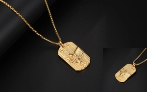 Detail of gold Taurus zodiac pendant featuring embossed bull head and hammer texture