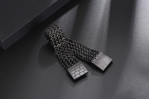 Macro shot of industrial black woven titanium steel bracelet with textured metal clasp