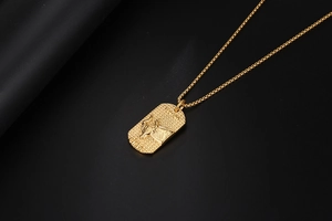 Detailed close-up of golden Taurus zodiac pendant with bull relief on matte background