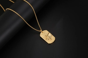 Detailed view of golden Taurus zodiac embossed pendant with bull head and polished finish