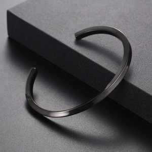 Minimalist black polished stainless steel twisted open bangle with sleek modern industrial finish