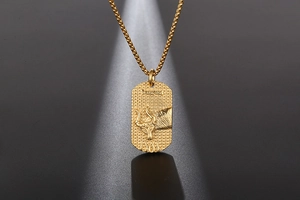 Macro shot of gold bull head pendant with textured surface and wheat chain link detail